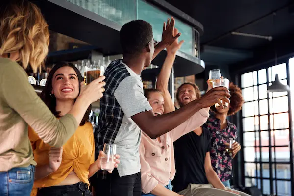 Adults enjoying premium bowling lanes and cocktails