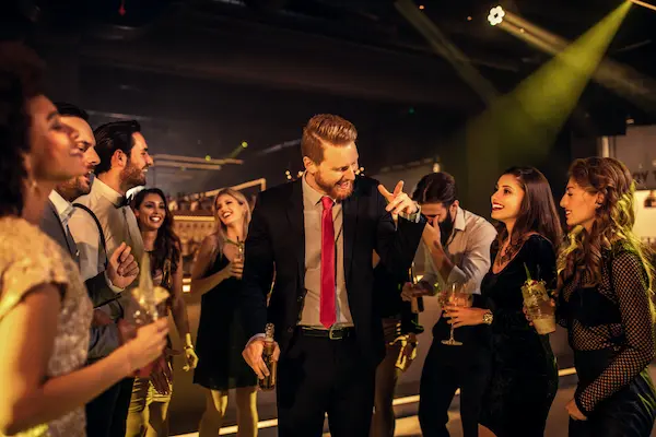 Adults enjoying premium bowling lanes and cocktails